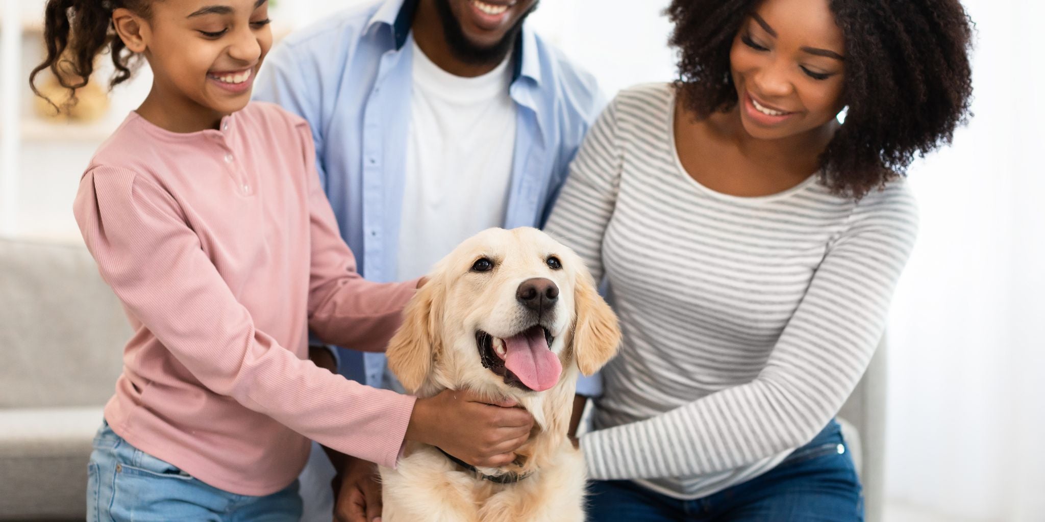 Family of three with a dog on a couch